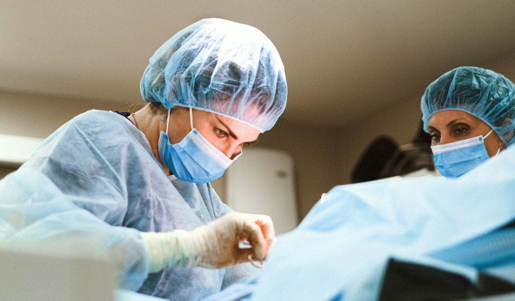 a surgeon operates on a patient with trust